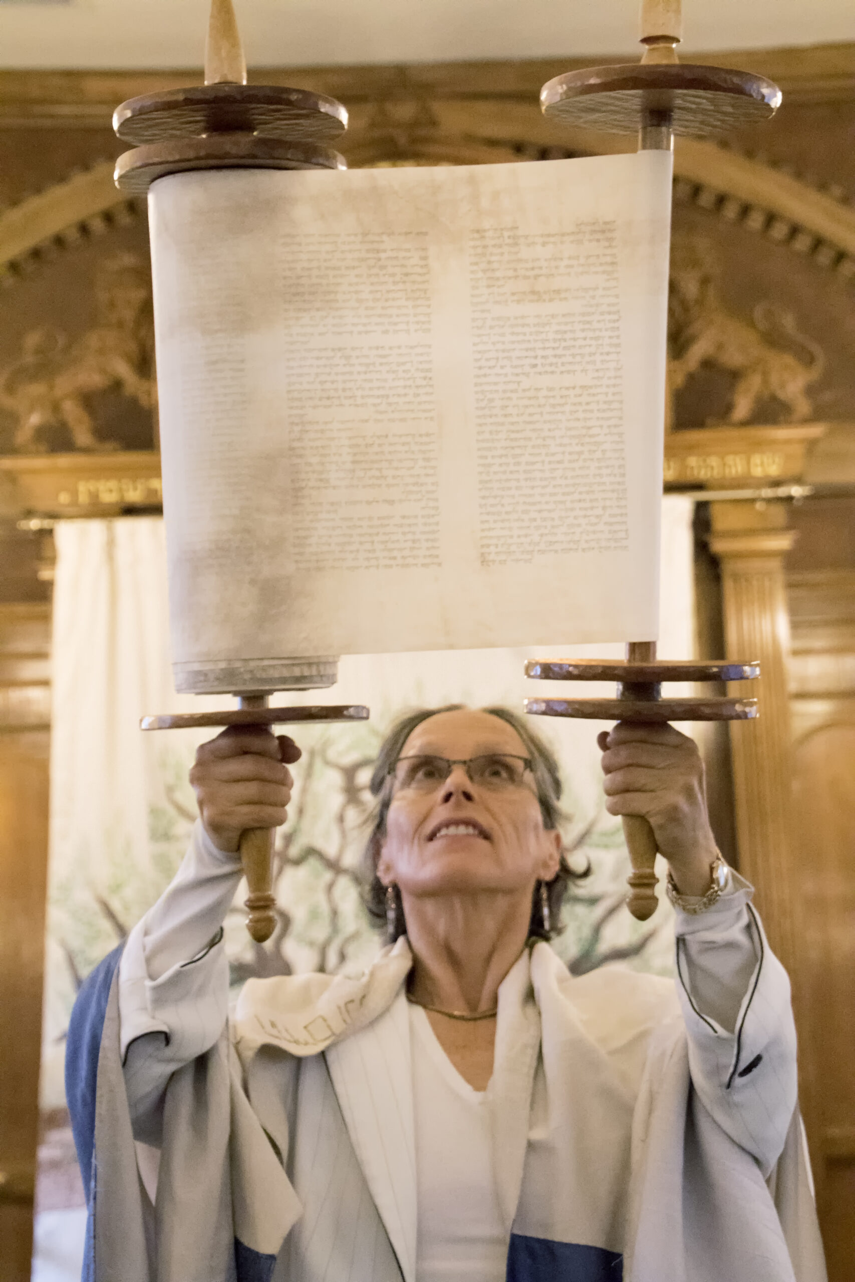 Diane Saxe holding up scroll